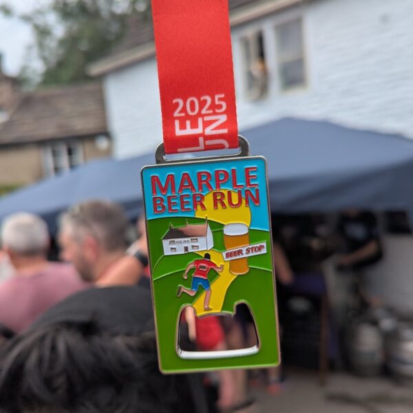 A Marple Beer Run medal in the shape of a bottle opener with an illustration of a runner, a pint and a pub.