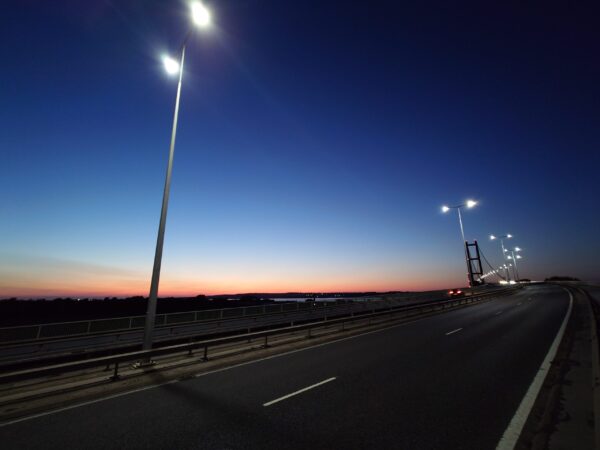 The Humber Bridge, with streetlights in the foreground, just after sunset.